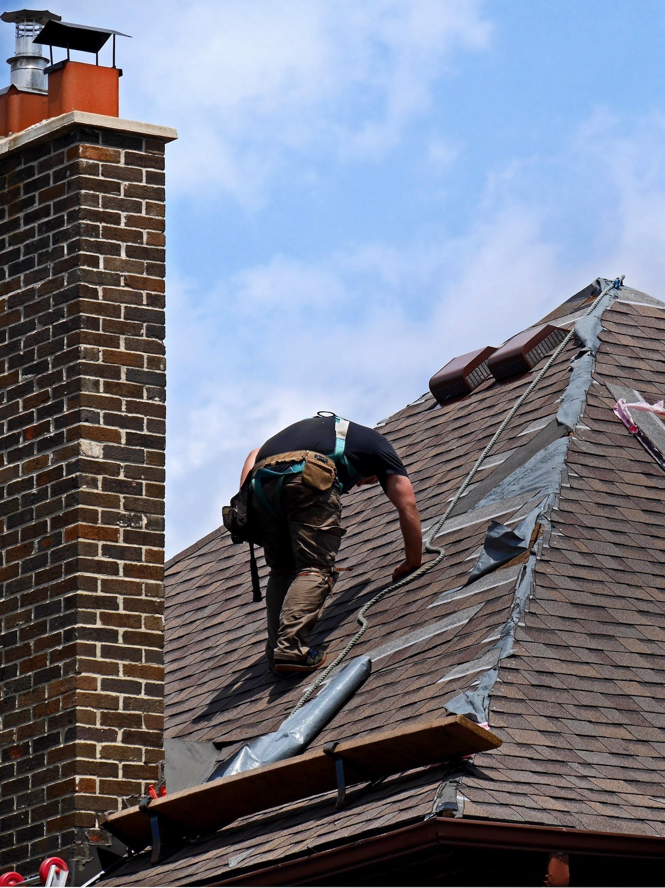 man fixing damaged roof