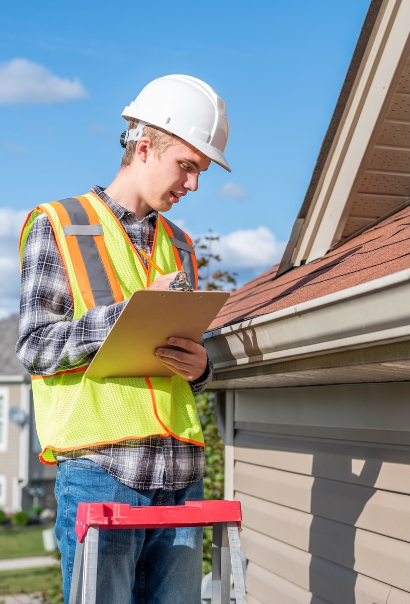 man inspecting roof