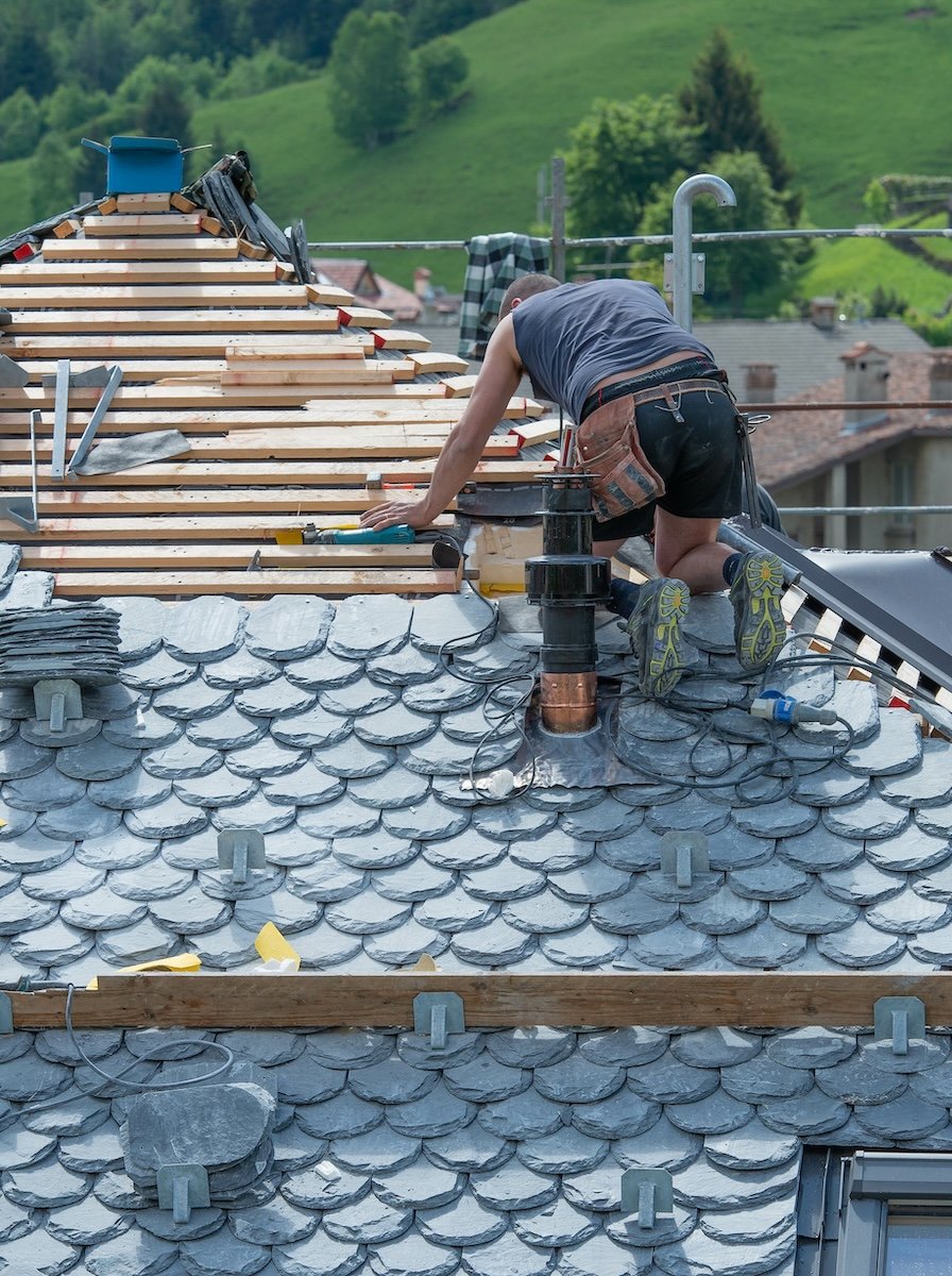 man installing slate roof