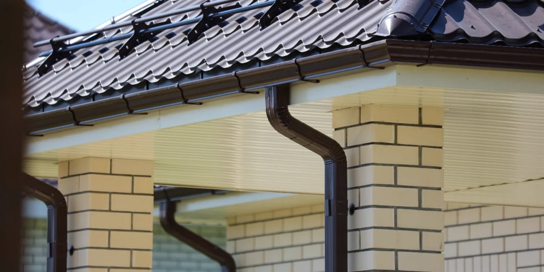 house roof gutter brick wall